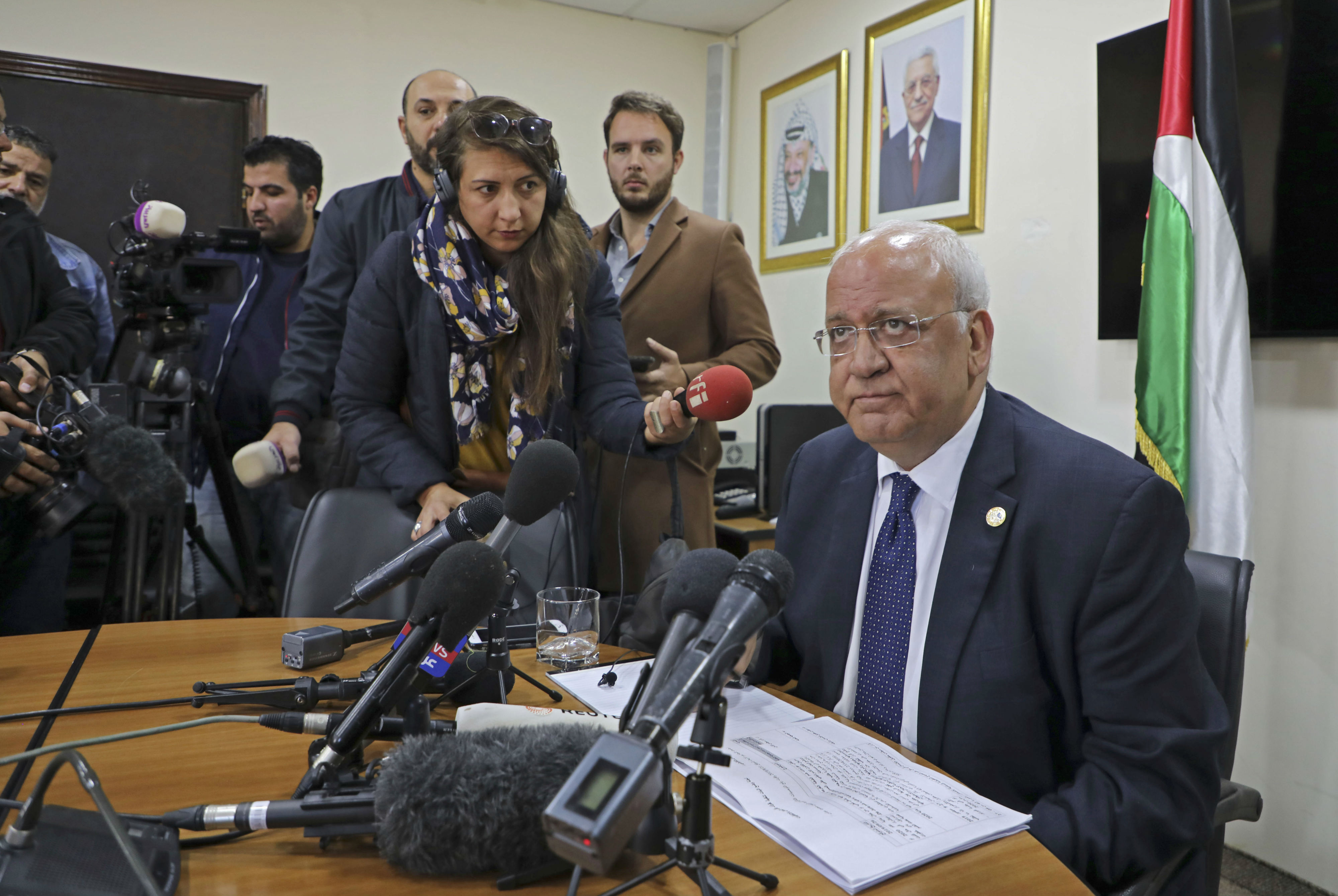 Saeb Erekat (R), Secretary General of the Palestine Liberation Organization (PLO) and chief Palestinian negotiator, speaks during a press conference in the Palestinian West Bank city of Ramallah (AFP)