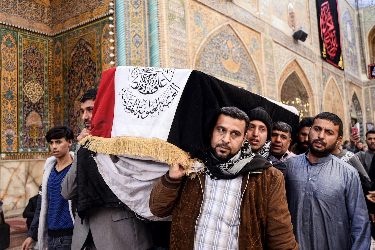 Mourners carry the coffin of a protester who was killed at an anti-government sit-in in Nasiriyah in Dhi Qar province, during his funeral in the central Iraqi holy shrine city of Najaf (AFP)
