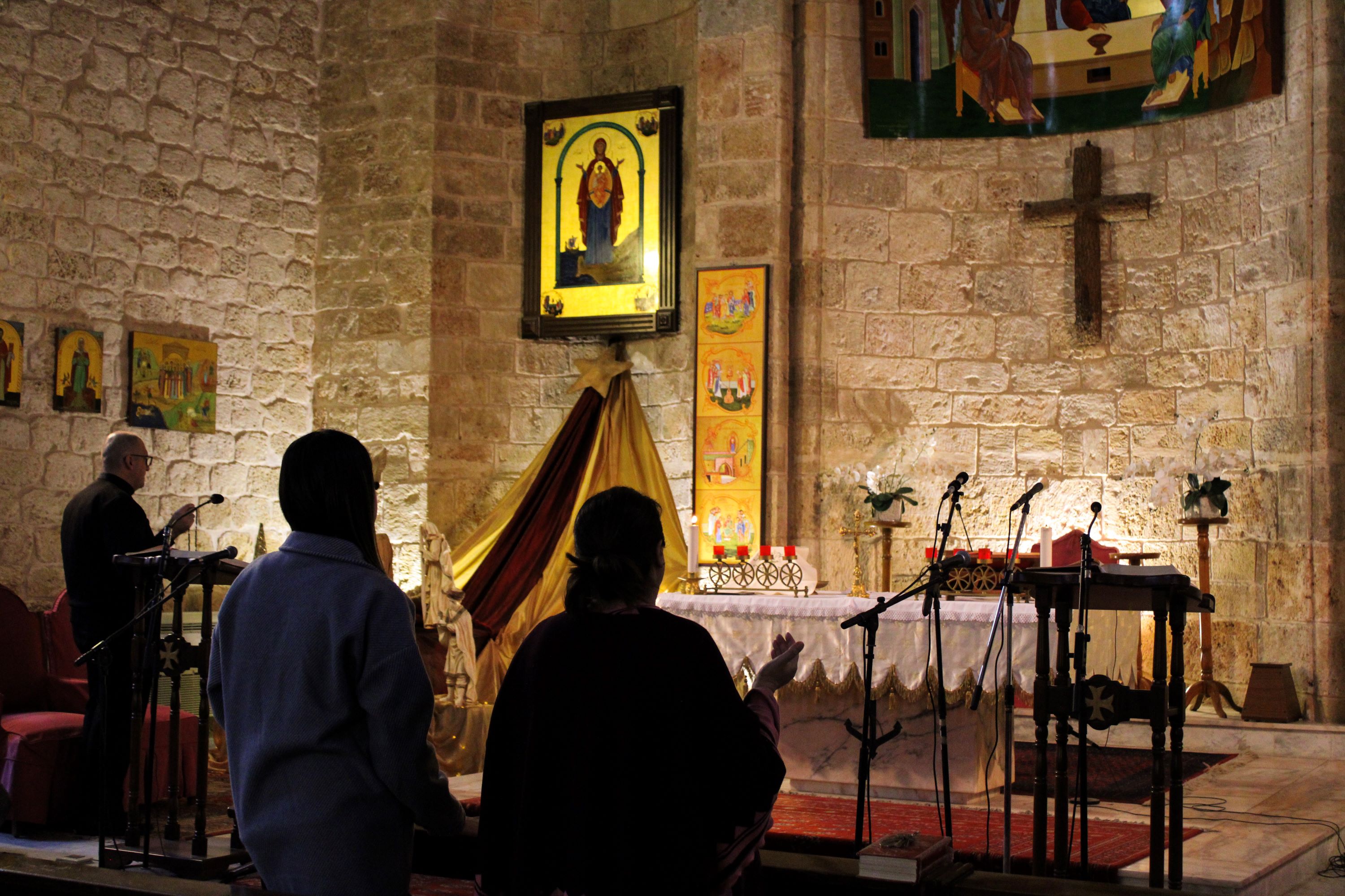 Father Saab Yaacoub leads a service at the “Our Lady of the Seas” Church on December 21 in Tyre (Hanna Davis/MEE)