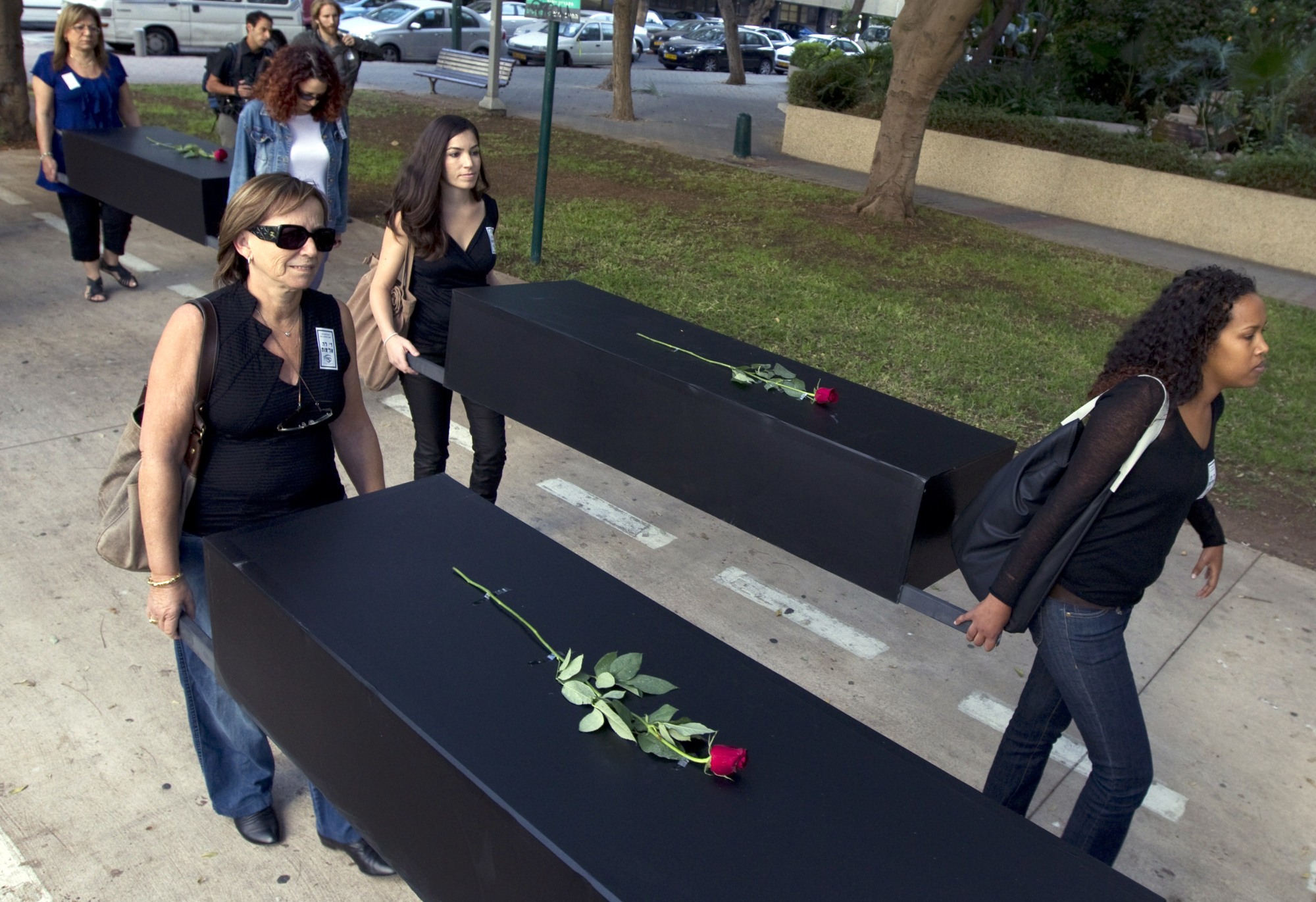 Israelis take part in a mock funeral to raise the alarm over the growing number of women being killed in incidents of domestic violence across Israel on 25 November 2010 in Tel Aviv (AFP)