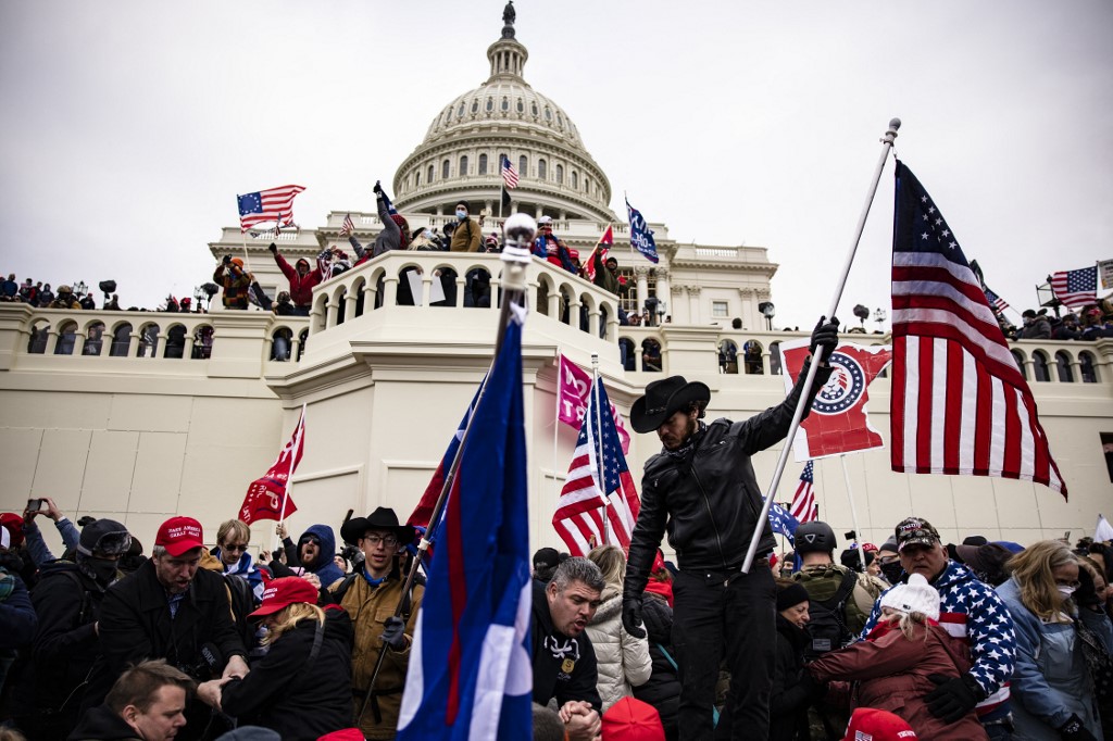 Pro-Donald Trump supporters storm the US Capitol on 6 January 2021 in Washington, DC (Samuel Corum/AFP)