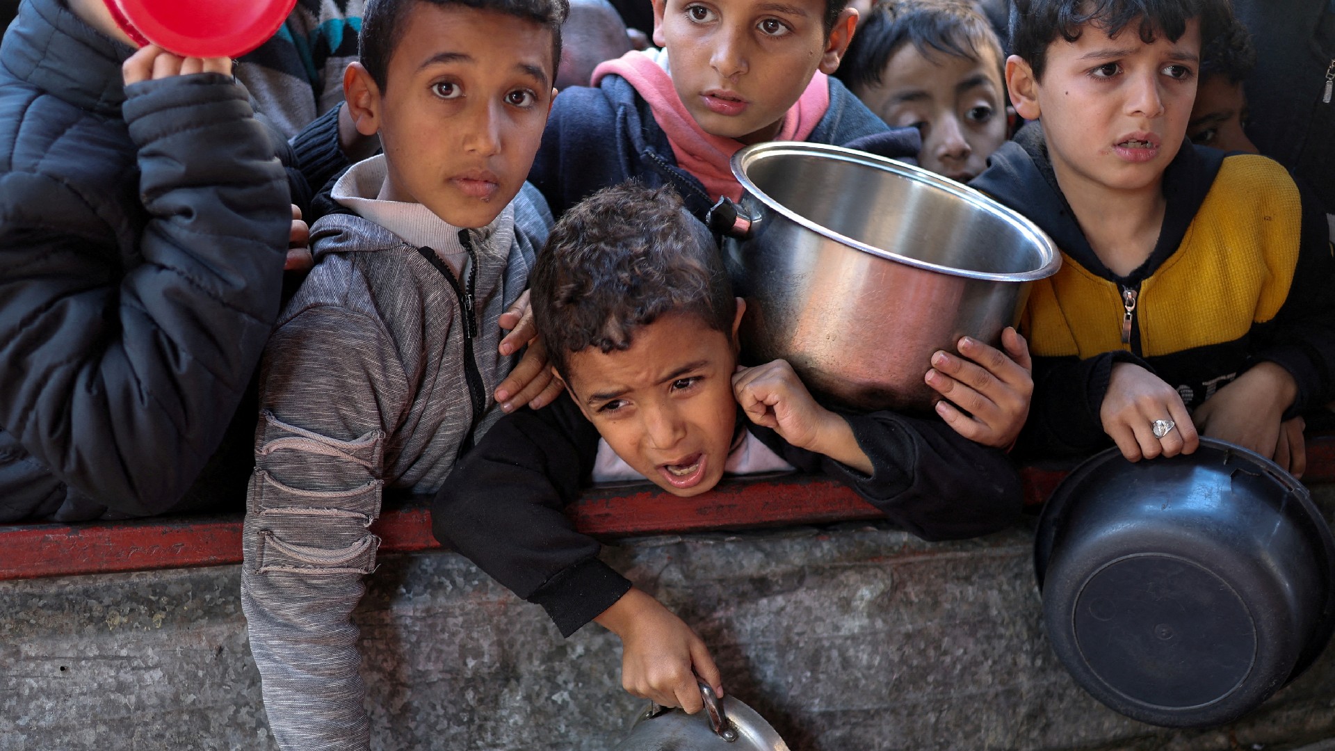 Palestinians wait for food