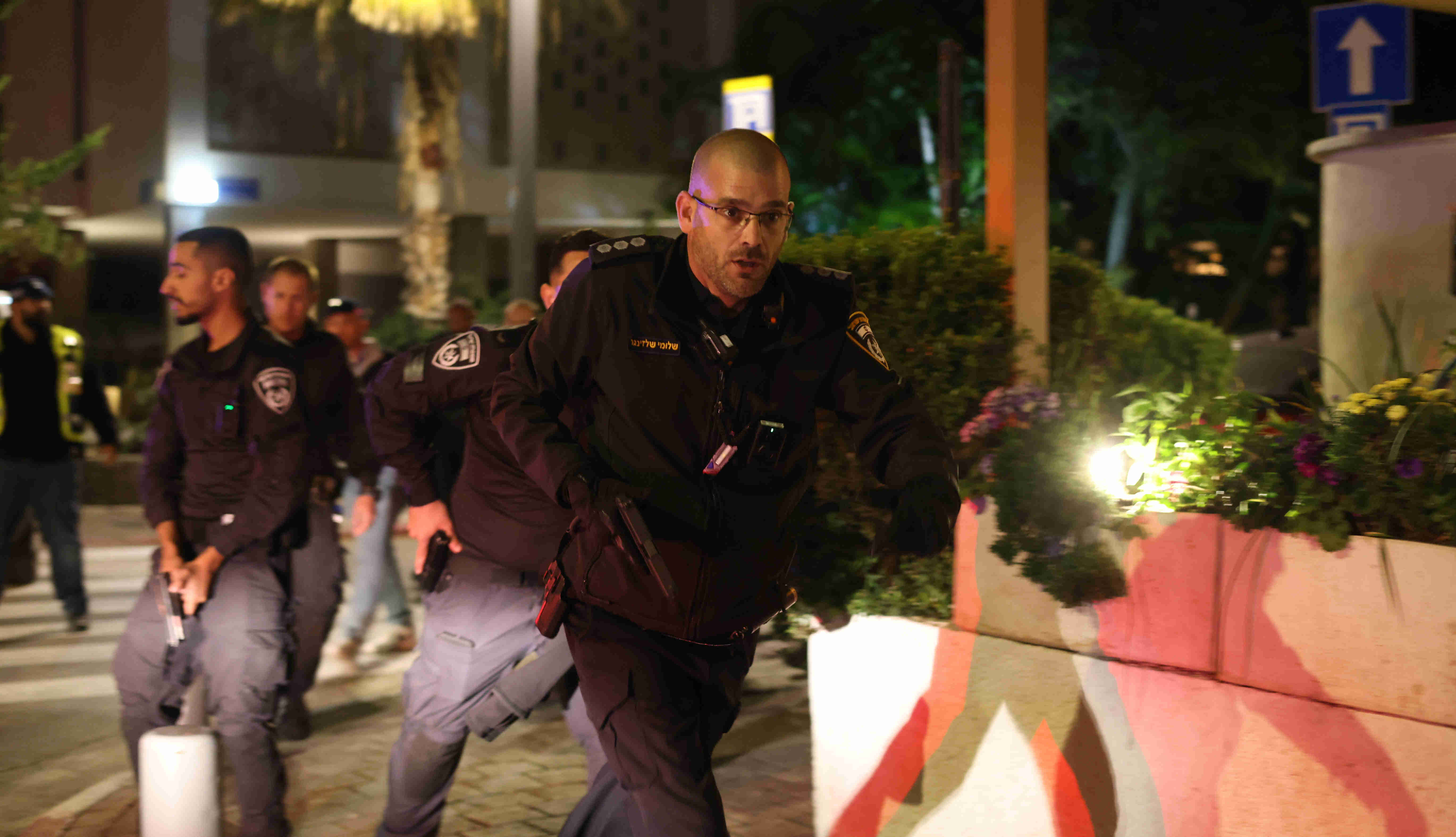 Oficial de policía israelí trabaja para asegurar la escena de un tiroteo en Tel Aviv el 9 de marzo de 2023 (MEE/Oren Ziv)