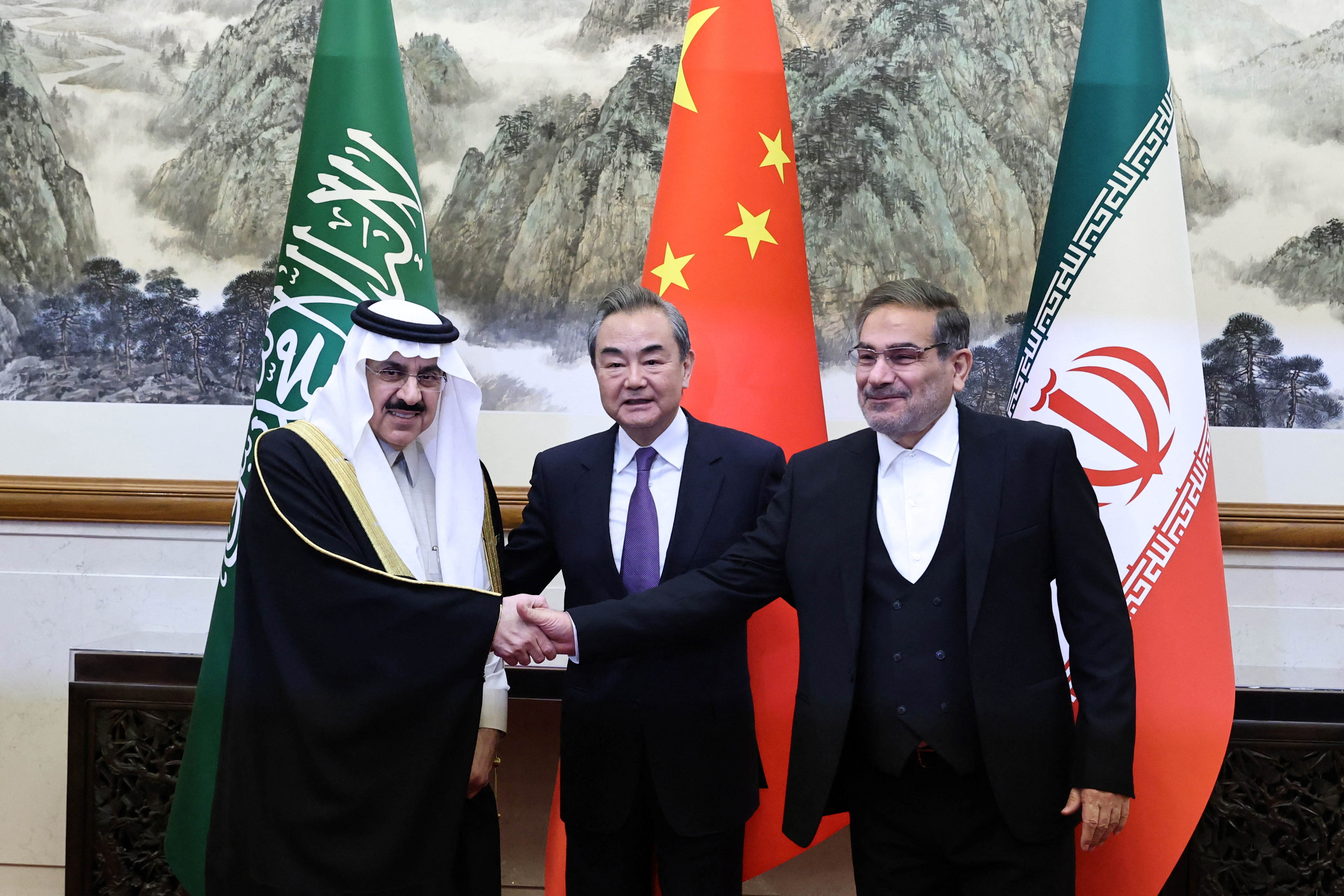 China's top diplomat Wang Yi with Saudi Arabia's Musaad bin Mohammed al-Aiban and Iran's Ali Shamkhani, in Beijing on 10 March 2023 (Reuters)