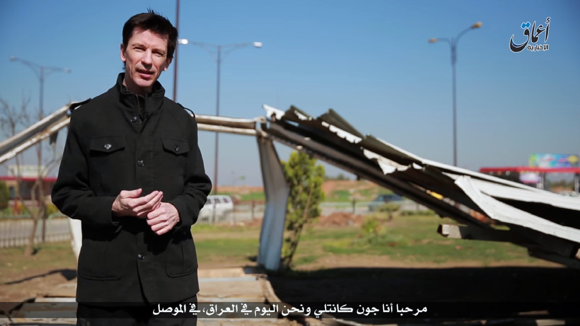 An image grab taken from a video uploaded on March 19, 2016 by Amaq News Agency, a Youtube channel which posts videos from areas under the Islamic State (IS) group's control, shows British journalist John Cantlie, who is being held prisoner by IS, speaking to the camera in the style of a news report supposedly filmed in the militants' northern Iraqi stronghold of Mosul (AFP)