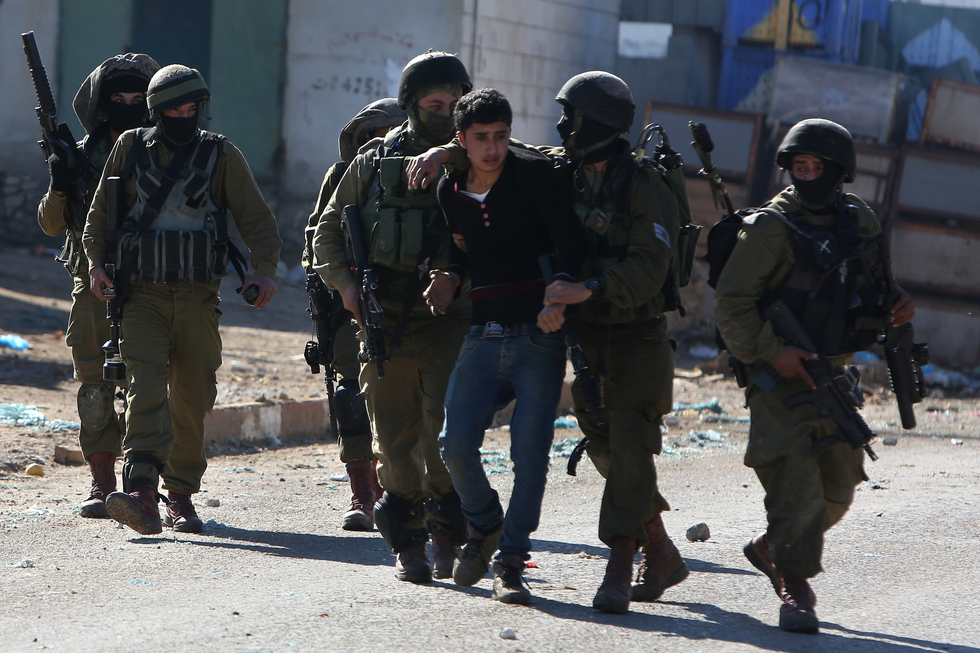 A Palestinian youth was arrested by Israeli police in Qabatiya on 4 February, 2016 (AFP)