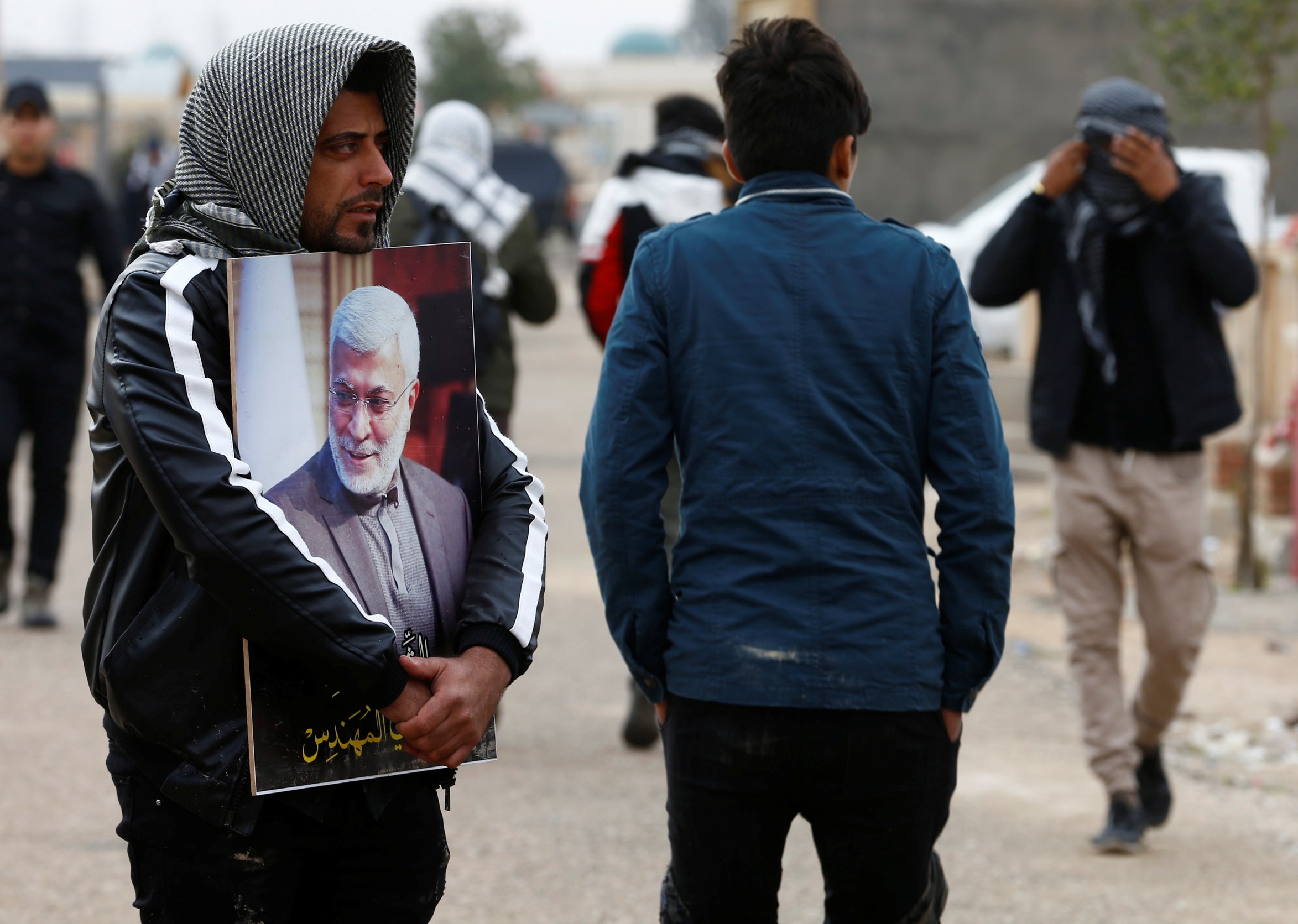 Mourners attend the burial of Iraqi militia commander Abu Mahdi al-Muhandis in Najaf on Wednesday (AFP)