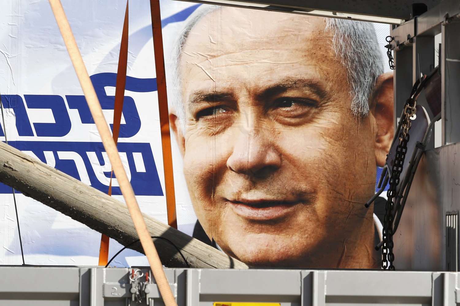 A youth walks past an election poster of  Benjamin Netanyahu, leader of the Likud party, in Tel Aviv, on 3 April 2019 (AFP)