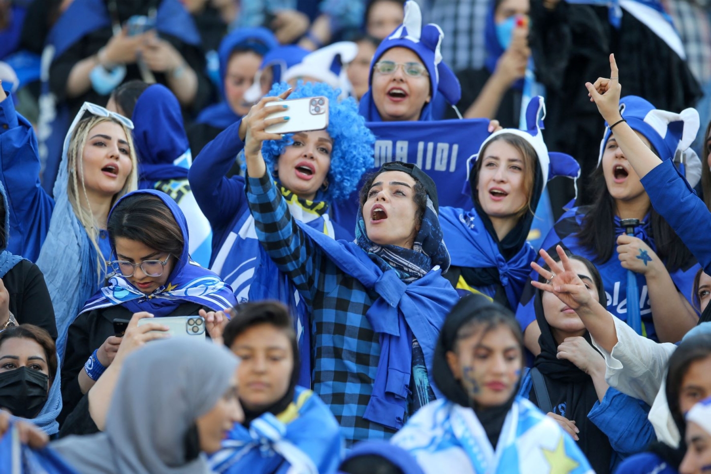Iranian women fans of Esteghlal football club cheer during a match between Esteghlal and Mes Kerman at the Azadi stadium in the capital Tehran, on August 25, 2022 (AFP)