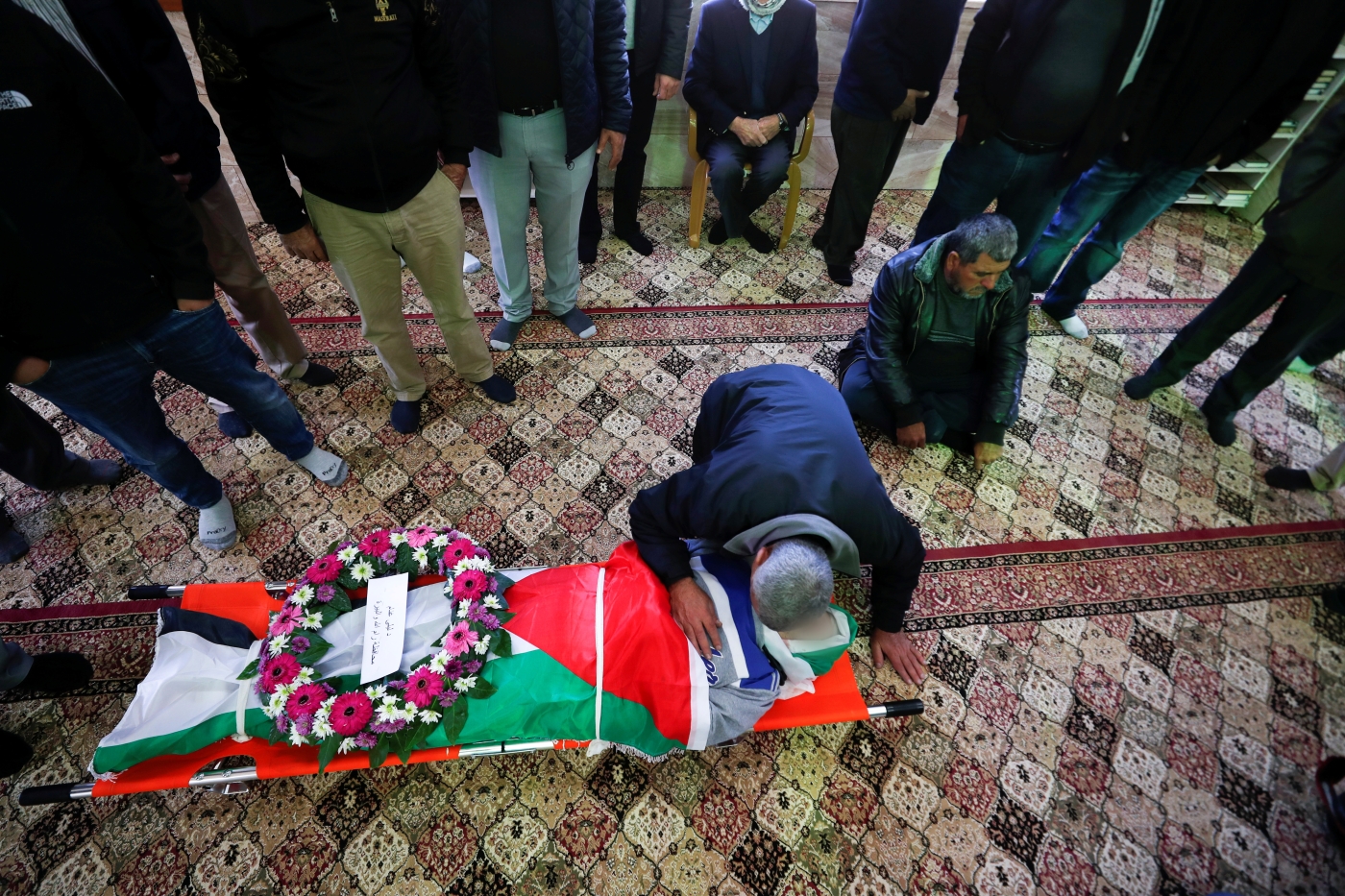 Mourners attend the funeral of Palestinian-American Omar Abdalmajeed Asaad, 79, on 13 January 2022 in Jiljilya village in the Israeli-occupied West Bank (Reuters)