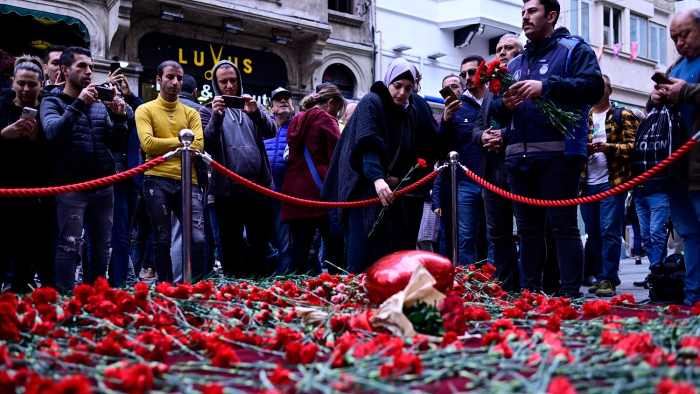 People lay flowers at a makeshift memorial for the victims of the 13 November explosion at the busy shopping street of Istiklal in Istanbul on 14 November 2022.