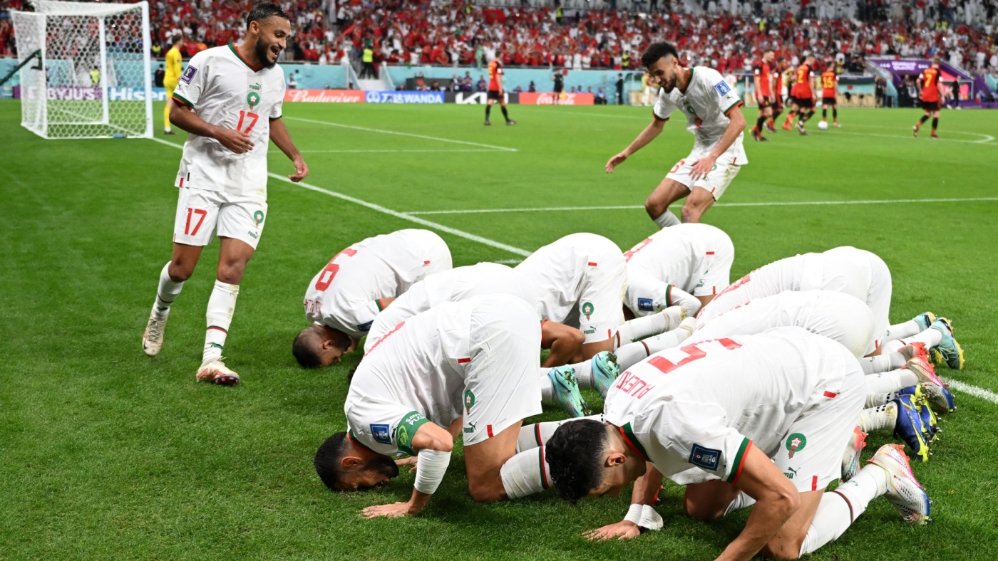 Morocco's players celebrate their win against Belgium at the Qatar World Cup on 27 November 2022 (AFP)