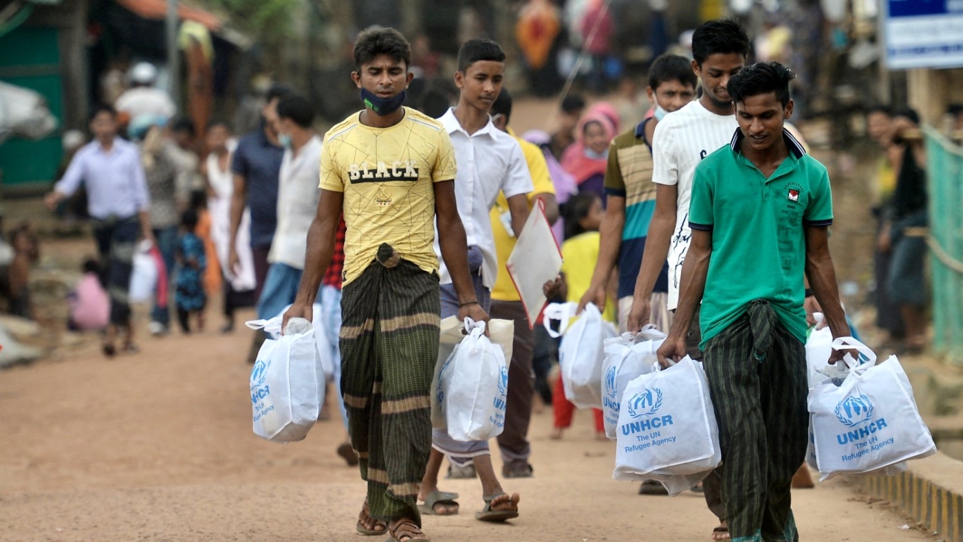 Rohingya refugees walk back home after collecting relief material in Ukhia, Bangladesh on 6 October 2022.