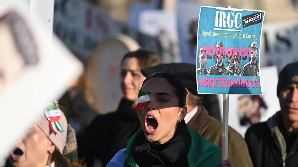 Protesters hold placards at a march in central London on 21 January 2023 against the Islamic Revolutionary Guard Corps.