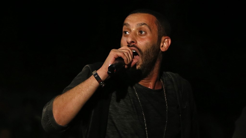 Palestinian rapper Tamer Nafar performs on-stage during a festival in the Sakhnin on Israel on 23 October 2016 (AFP)