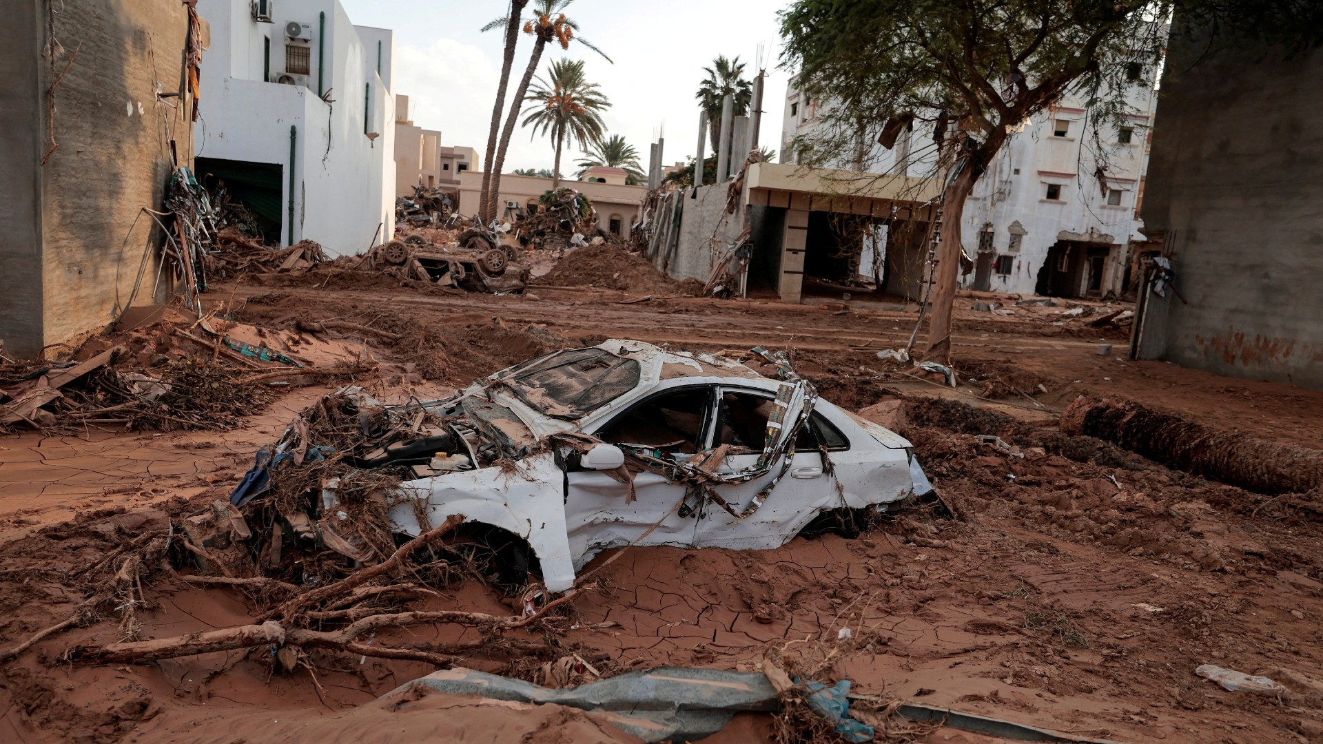 A car is submerged in mud after a powerful storm and heavy rainfall hit Libya, in Derna, 16 September
