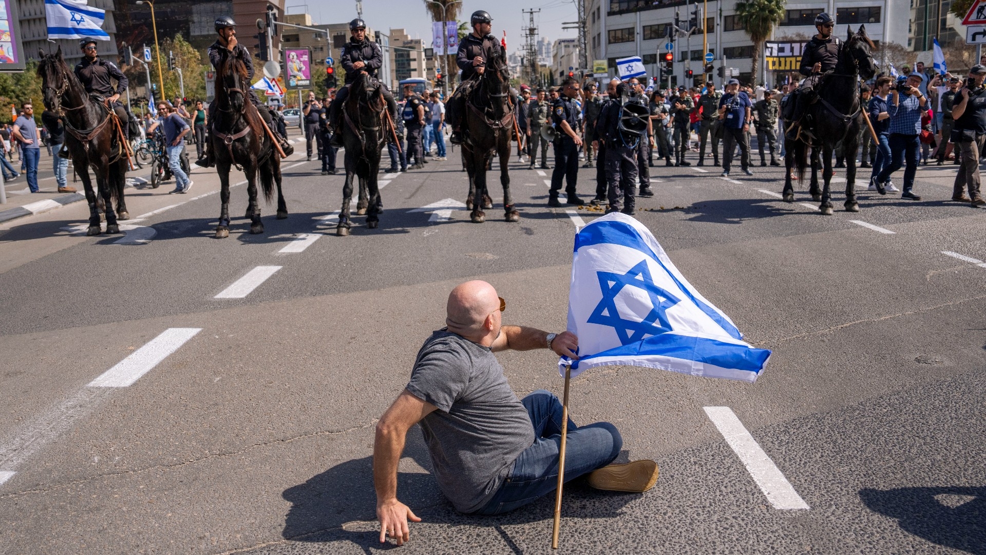 Mounted police are deployed as Israelis block a main road to protest against plans by Prime Minister Benjamin Netanyahu's government to overhaul the judicial system, in Tel Aviv, 1 March (AP)