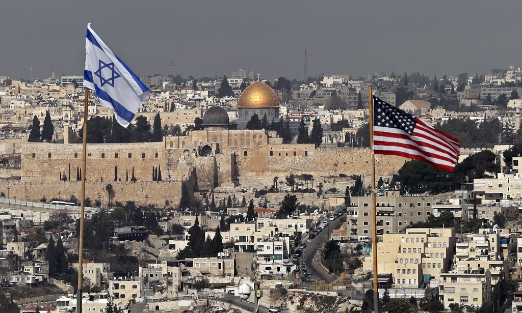 Israeli and US flags placed on the roof of an Israeli settlement building in occupied East Jerusalem