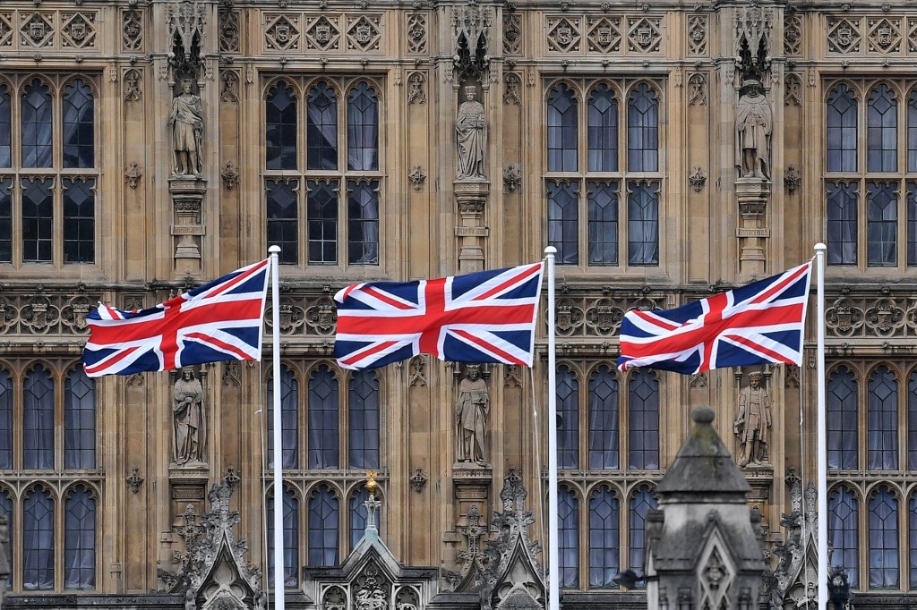 Union flags flutter outside the Palace of Westminster in central London on 25 March 2021 (AFP)