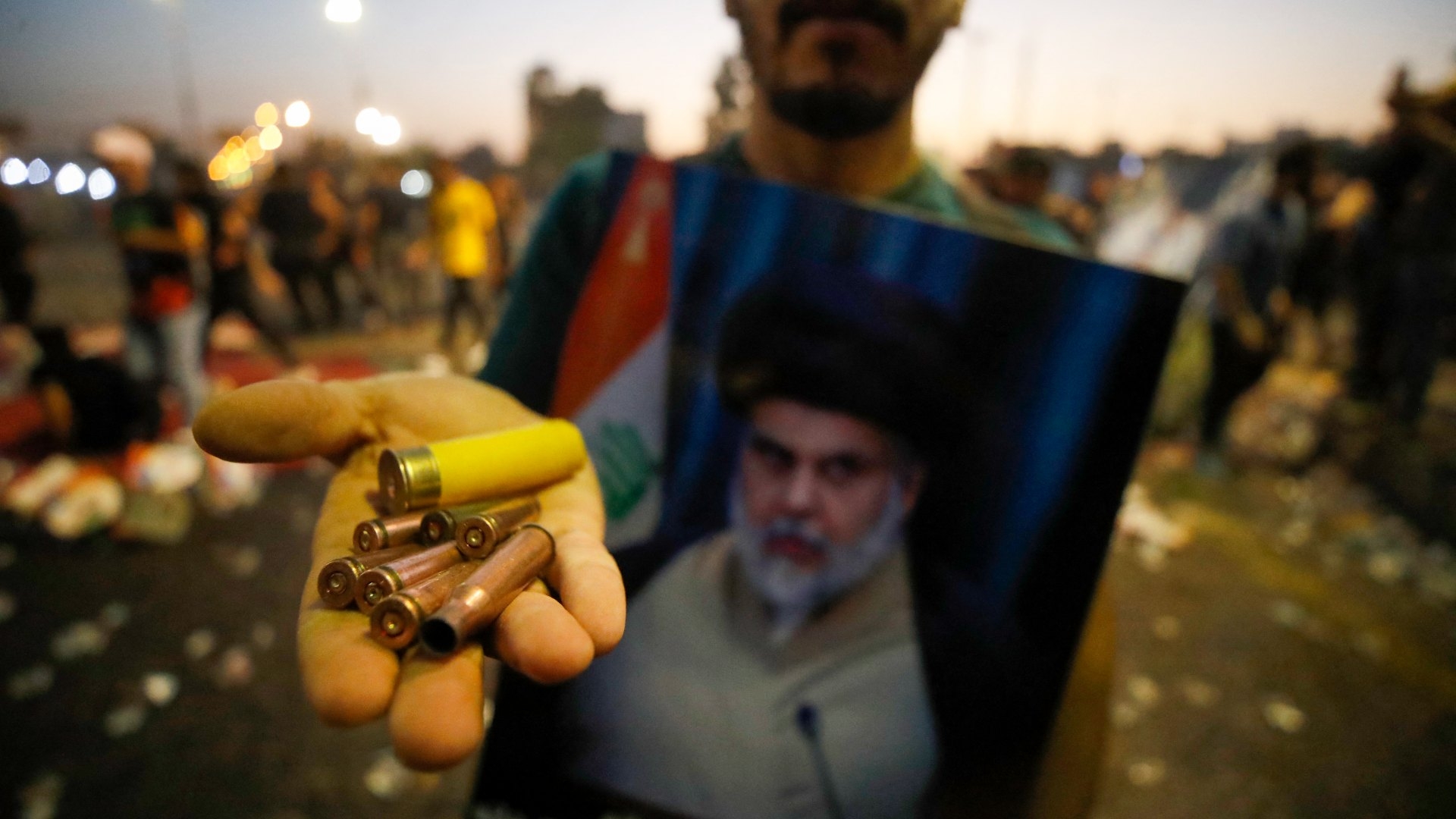 A supporter of Iraqi Shiite cleric Moqtada Sadr carries bullet casings and a spent shotgun shell in the capital Baghdad, on 29 August 2022