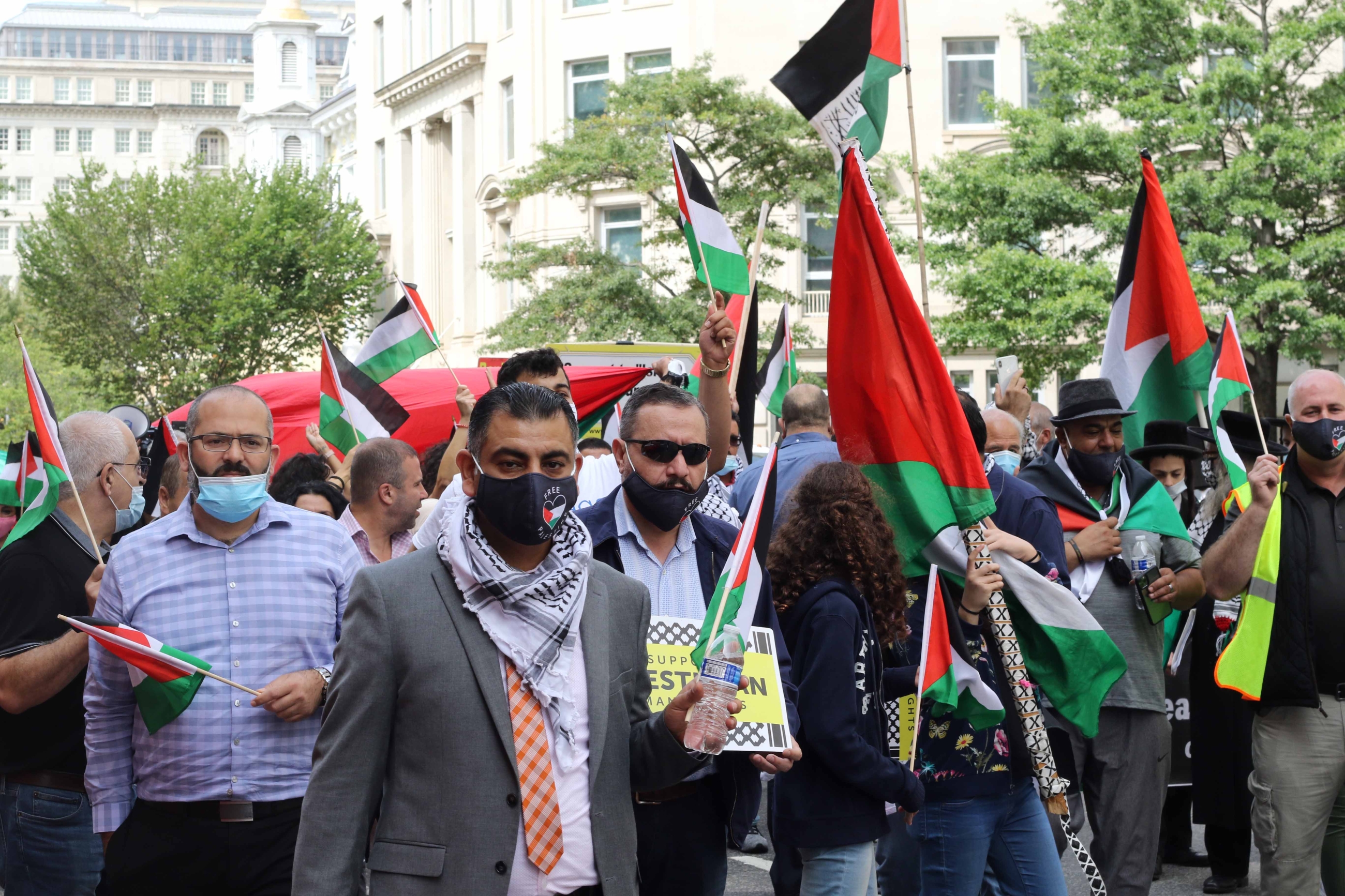 The protesters marched on the streets just outside the White House, waving Palestinian flags and chanting 'Free Palestine'.