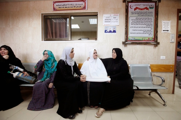 Women wait to be evacuated from al-Aqsa hospital (MEE / Eloise Bollack)
