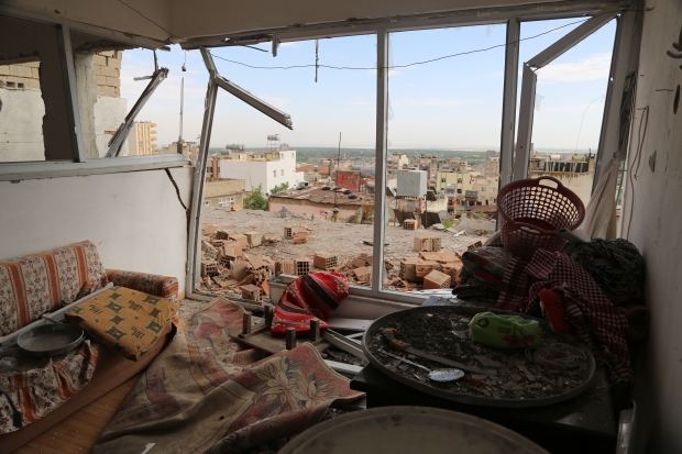 Family's home was struck by rocket attack, leaving debris scattered across floor (MEE/Ibrahim Jawdat)