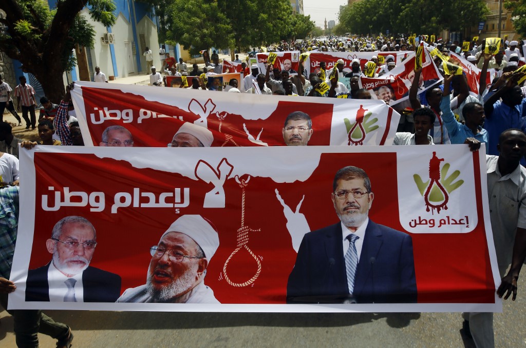 Sudanese Islamists protest the death sentences handed down to former Egyptian President Mohamed Morsi, Badie and other co-defendants in 2015 (AFP)