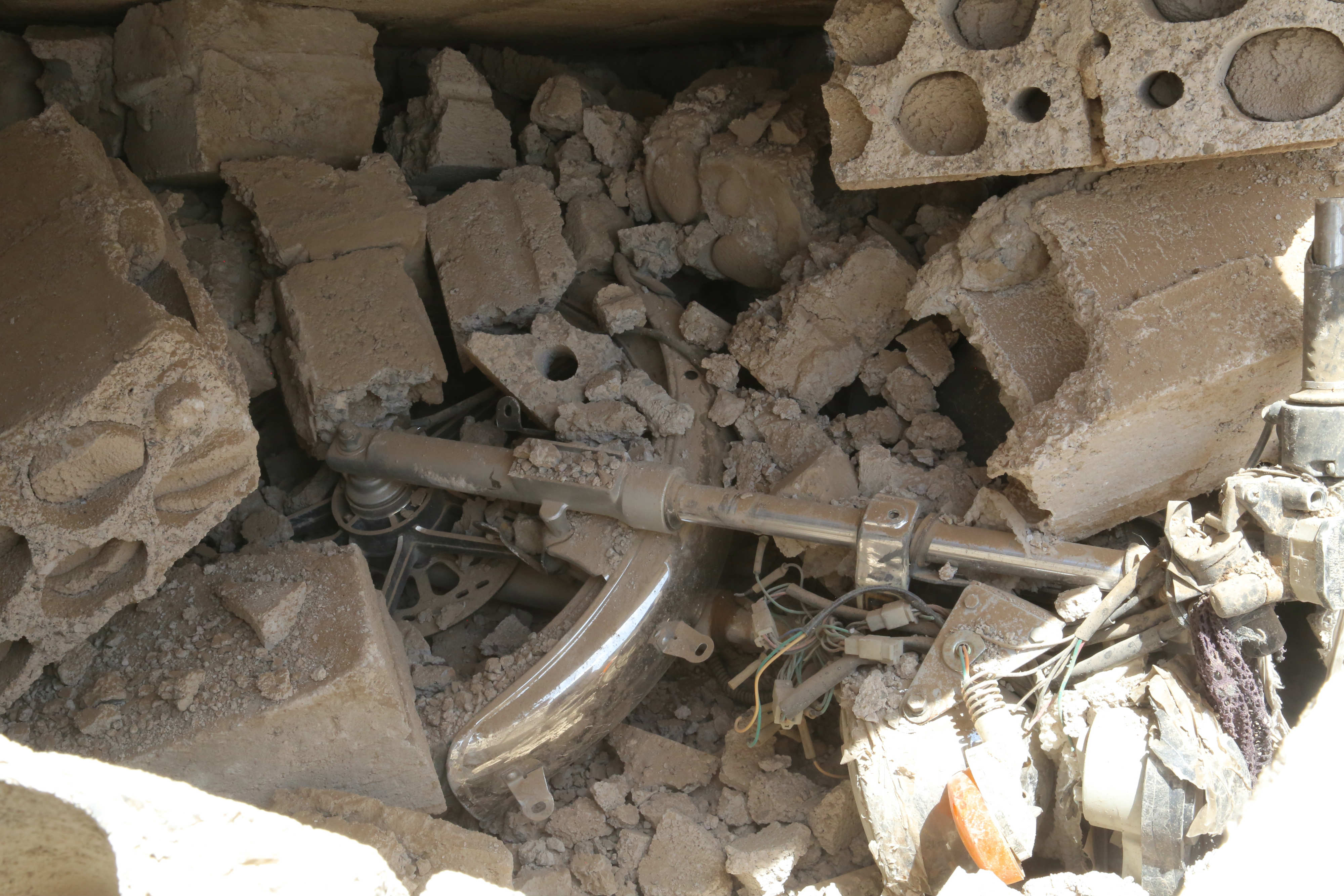 A child's bicycle is seen among the rubble following the bombings in Saawan (MEE)