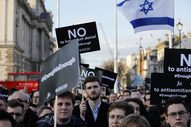 Members of the Jewish community protest against Corbyn in London on 26 March 2018 (AFP)
