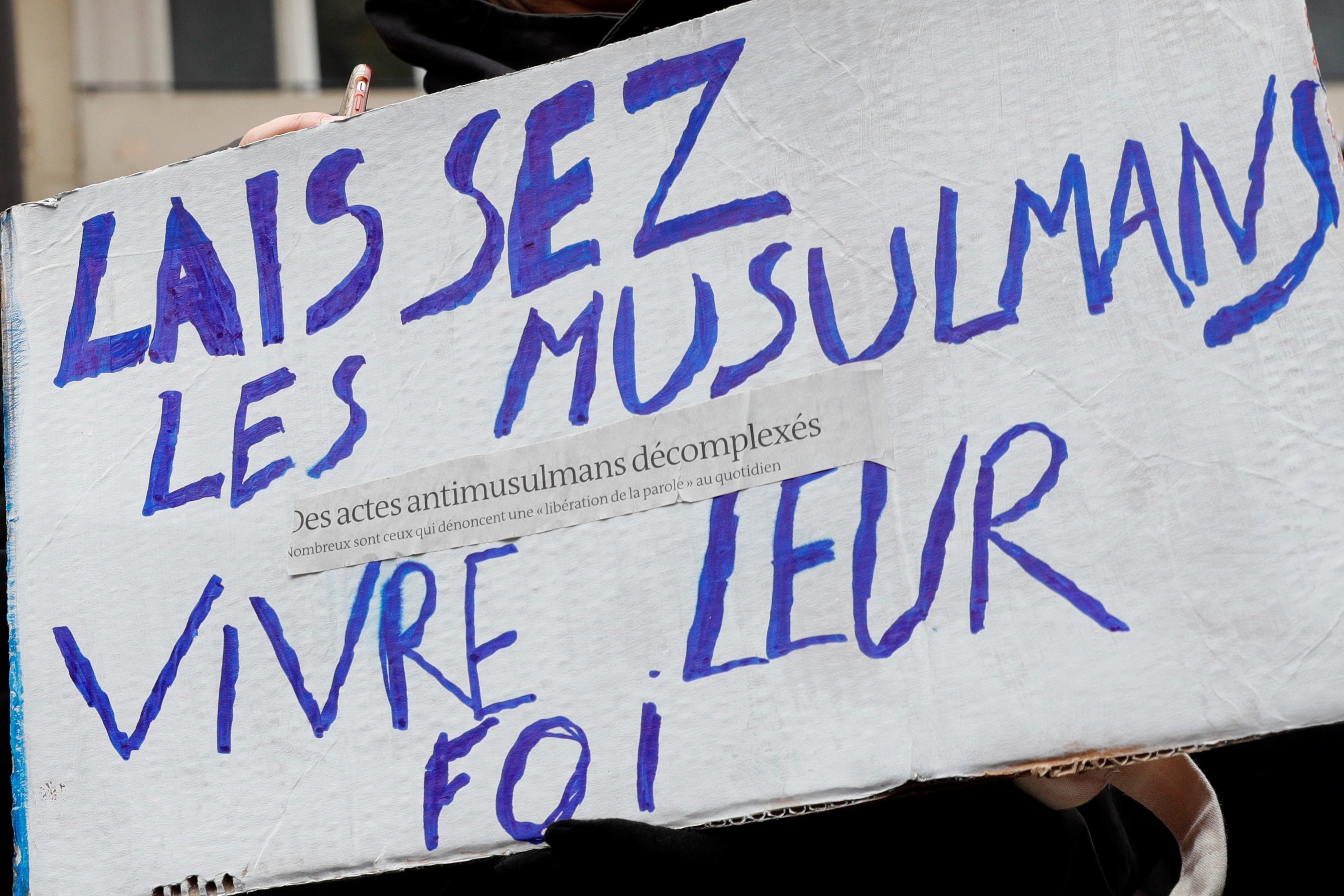 A placard held by a protester reading 