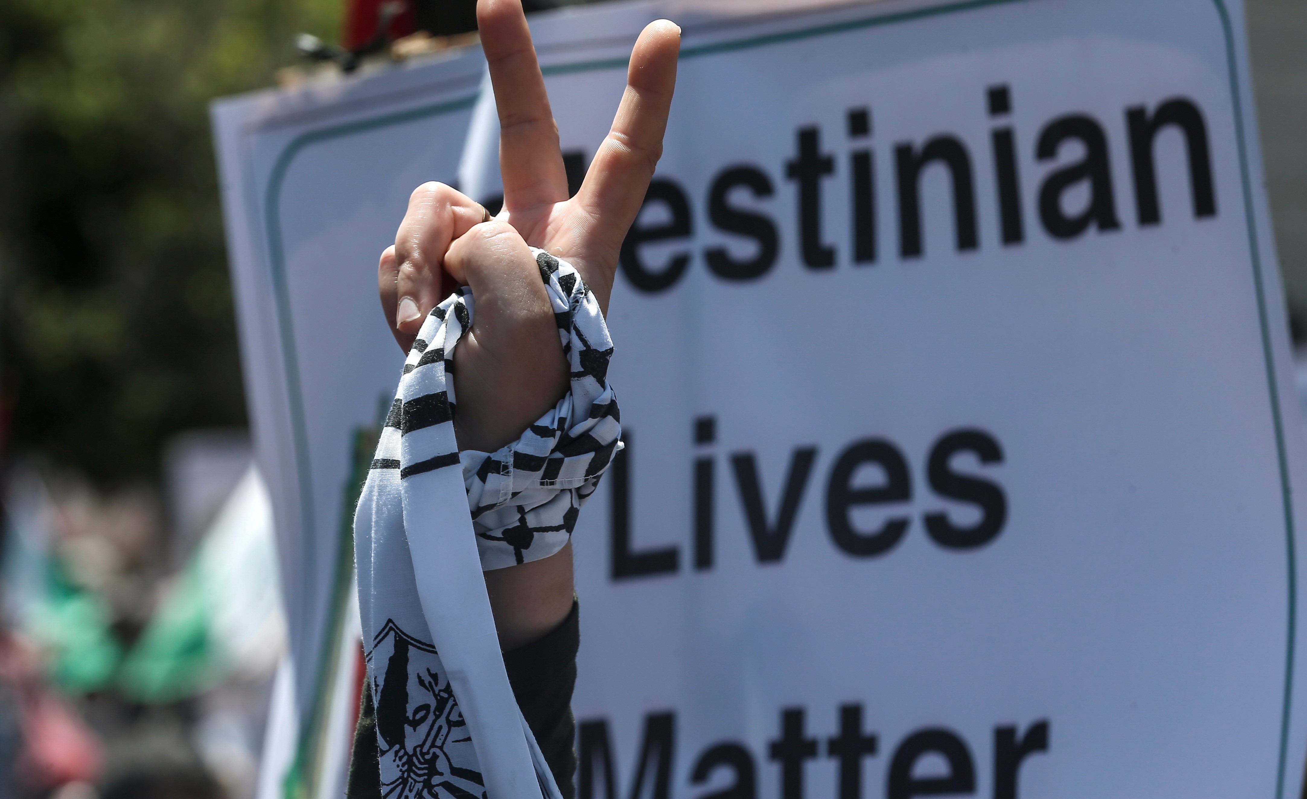 A Palestinian demonstrator flashes the victory sign during a rally as Palestinians call for a "Day of Rage" to protest Israel's plan to annex parts of the occupied West Bank, in Gaza City on July 1, 2020. 