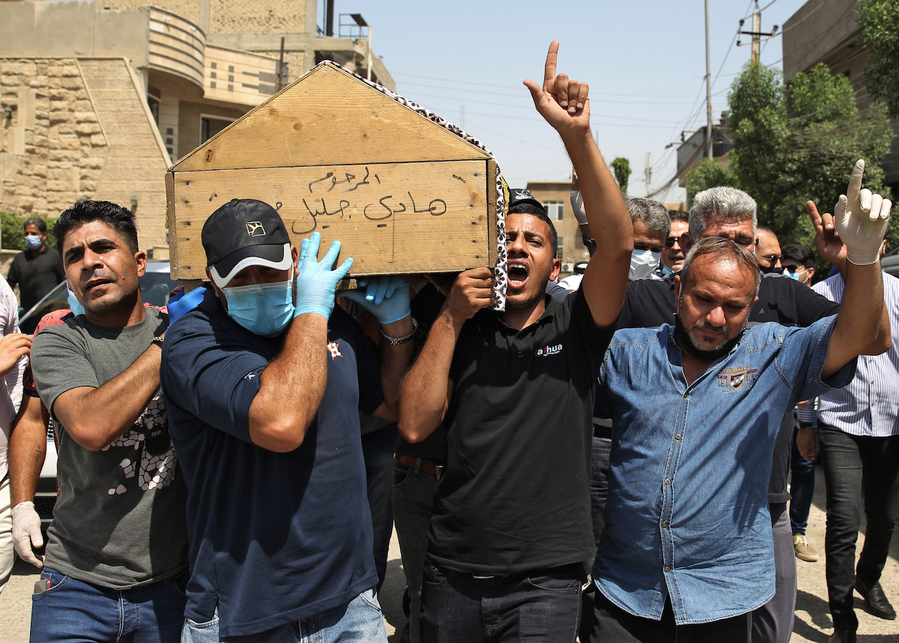 Mourners carry the coffin of slain Iraqi expert Hisham al-Hashemi, who was shot dead yesterday outside his house in the Iraqi capital, during his funeral in Baghdad’s Zayouna district (AFP)
