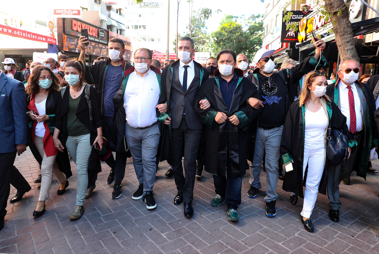 Protesting lawyers lock arms as they march during a demonstration against a government draft bill on changing the system of bar associations on July 10, 2020, in Ankara. Turkey's ruling party on June 30 presented a bill to parliament on changing the system of bar associations that opponents say will dent lawyers' independence and influence. 