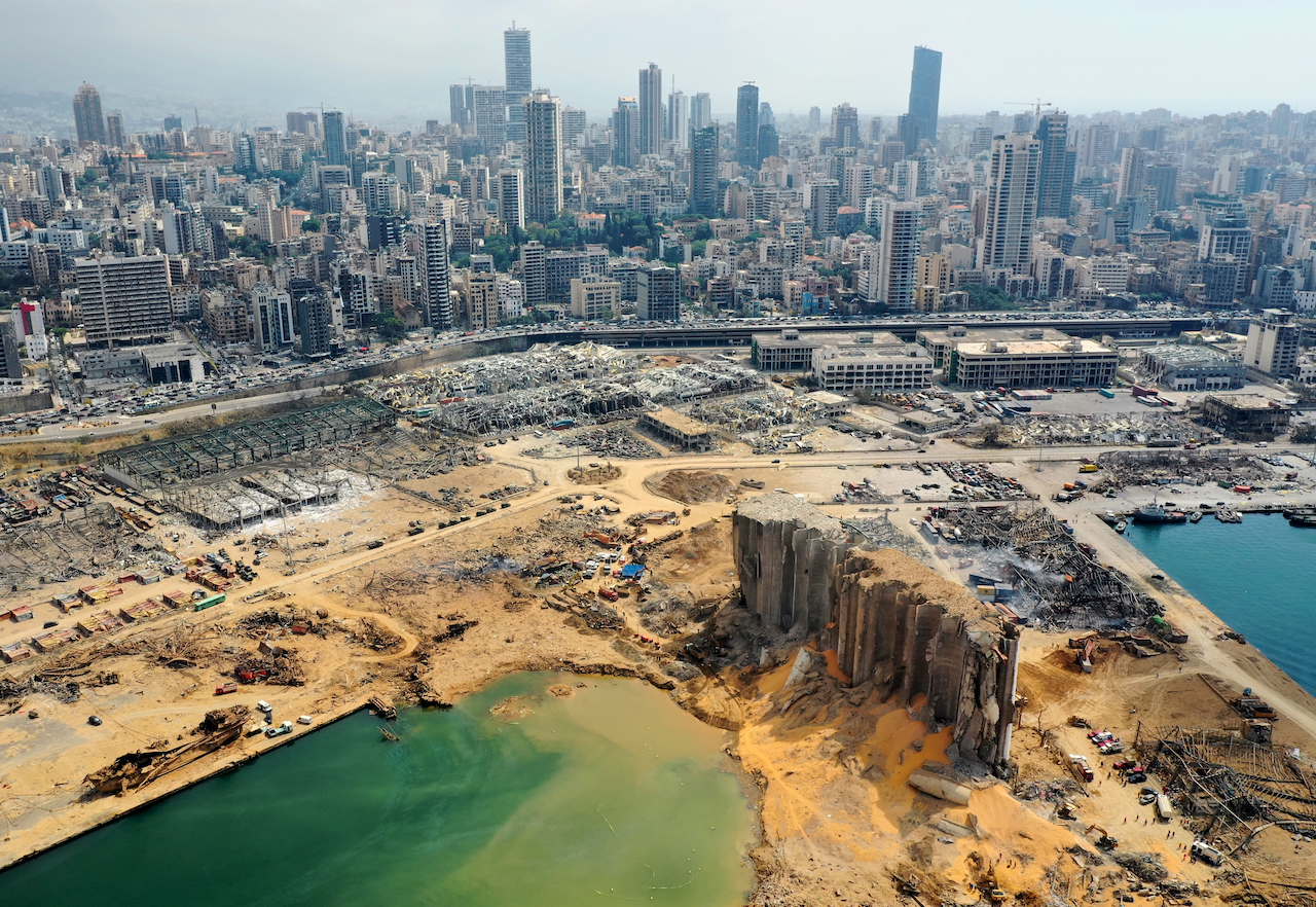 An aerial view taken on August 7, 2020, shows a partial view of the port of Beirut, the damaged grain silo and the crater caused by the colossal explosion (AFP)