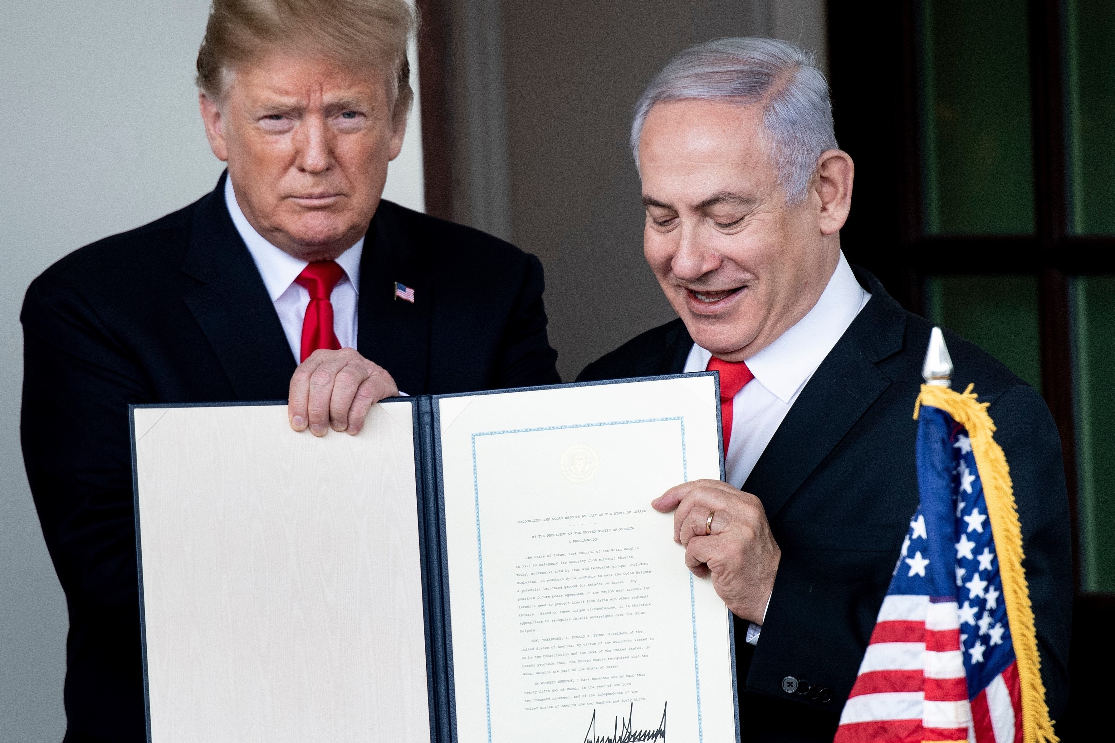 US President Donald Trump (L) and Israel's Prime Minister Benjamin Netanyahu hold up a Golan Heights proclamation on 25 March, 2019 in Washington (AFP)