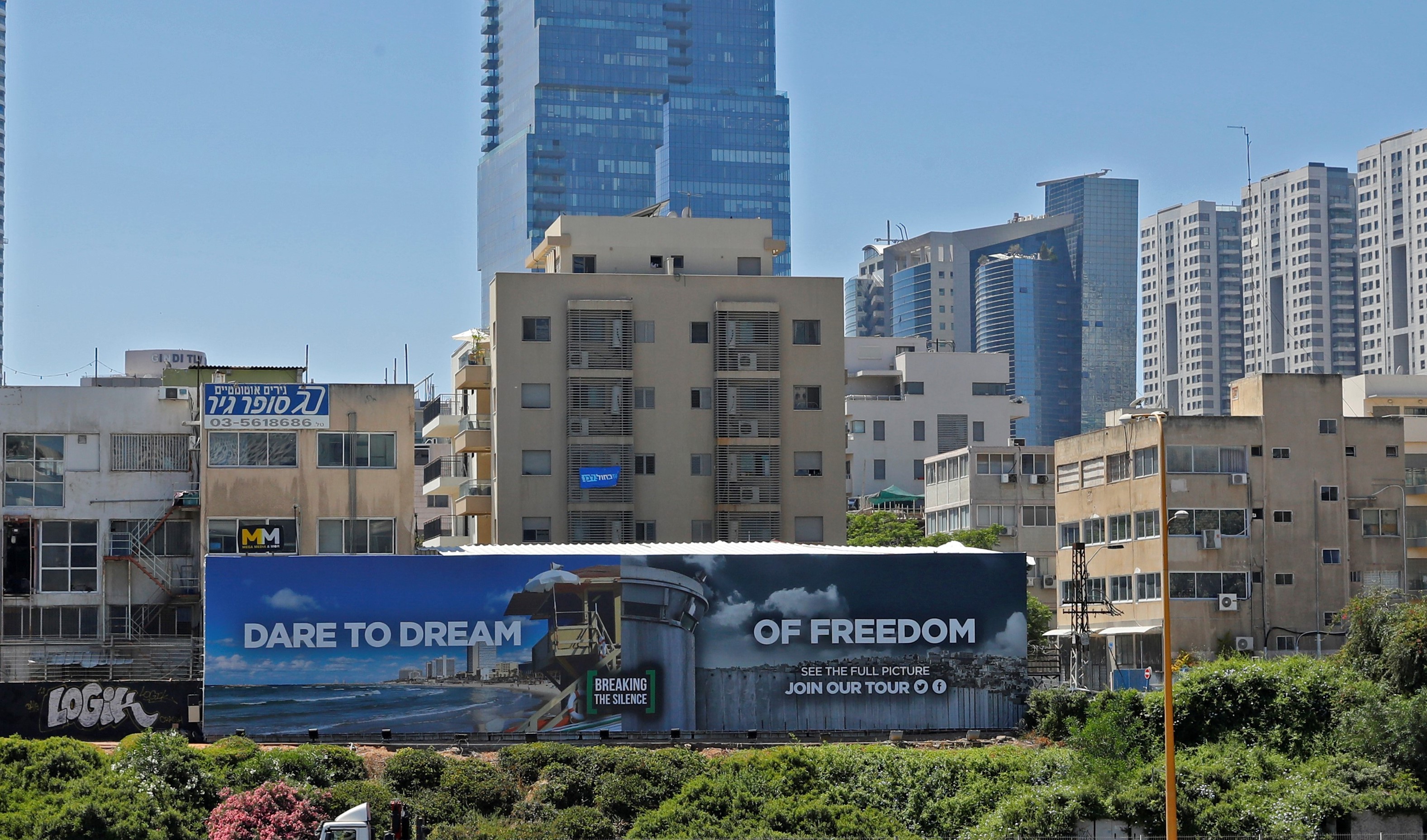 A picture taken on May 13, 2019, shows an anti-occupation billboard, by Israeli NGO Breaking The Silence, erected on a street in the Israeli coastal city of Tel Aviv (AFP)