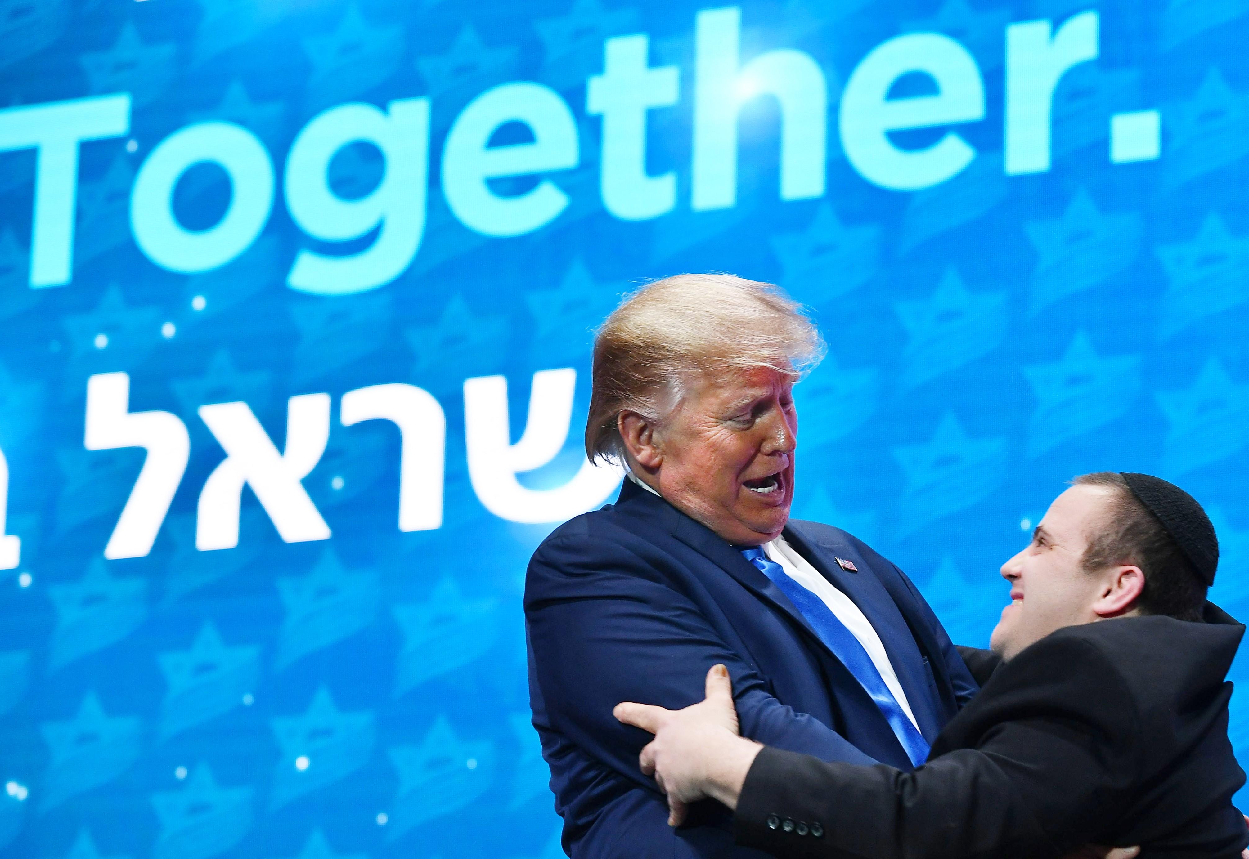 US President Donald Trump greets members of the Shalva Band after their performance at the Israeli American Council National Summit 2019 on 7 December (AFP)
