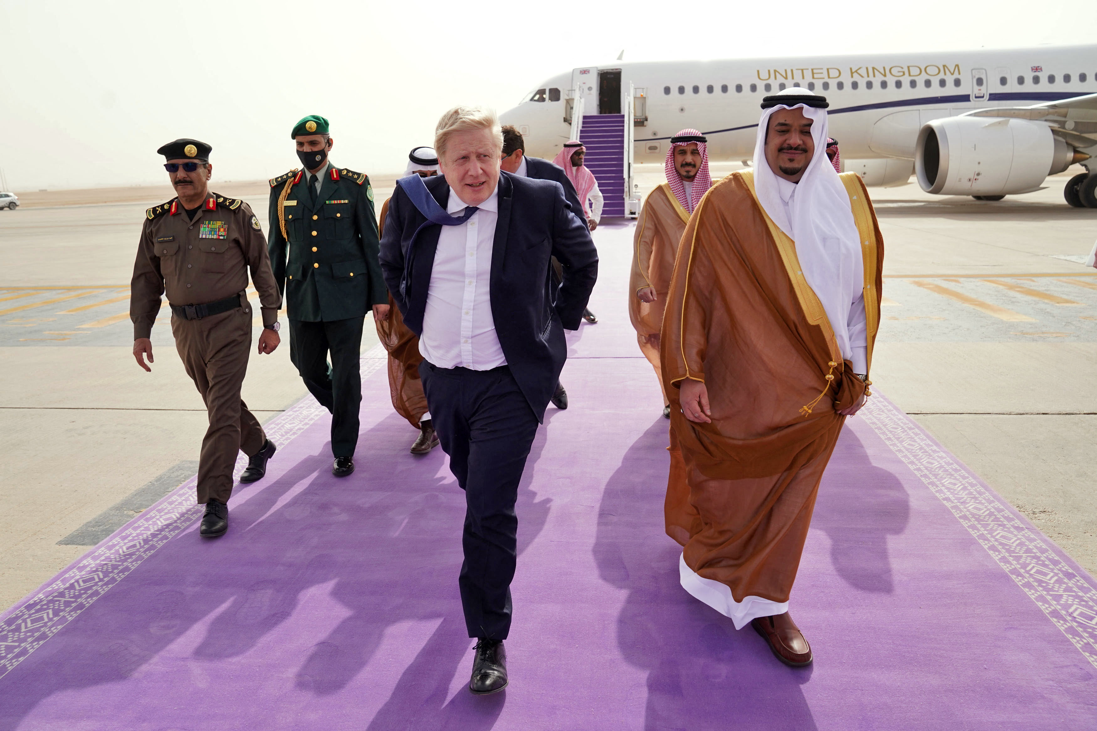 British Prime Minister Boris Johnson (C) arrives at Riyadh Airport during a one-day visit to Saudi Arabia and the United Arab Emirates (AFP)