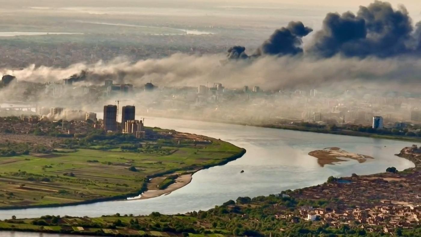 An aerial view of black smoke covering the sky above the Sudanese capital Khartoum on 19 April (AFP)