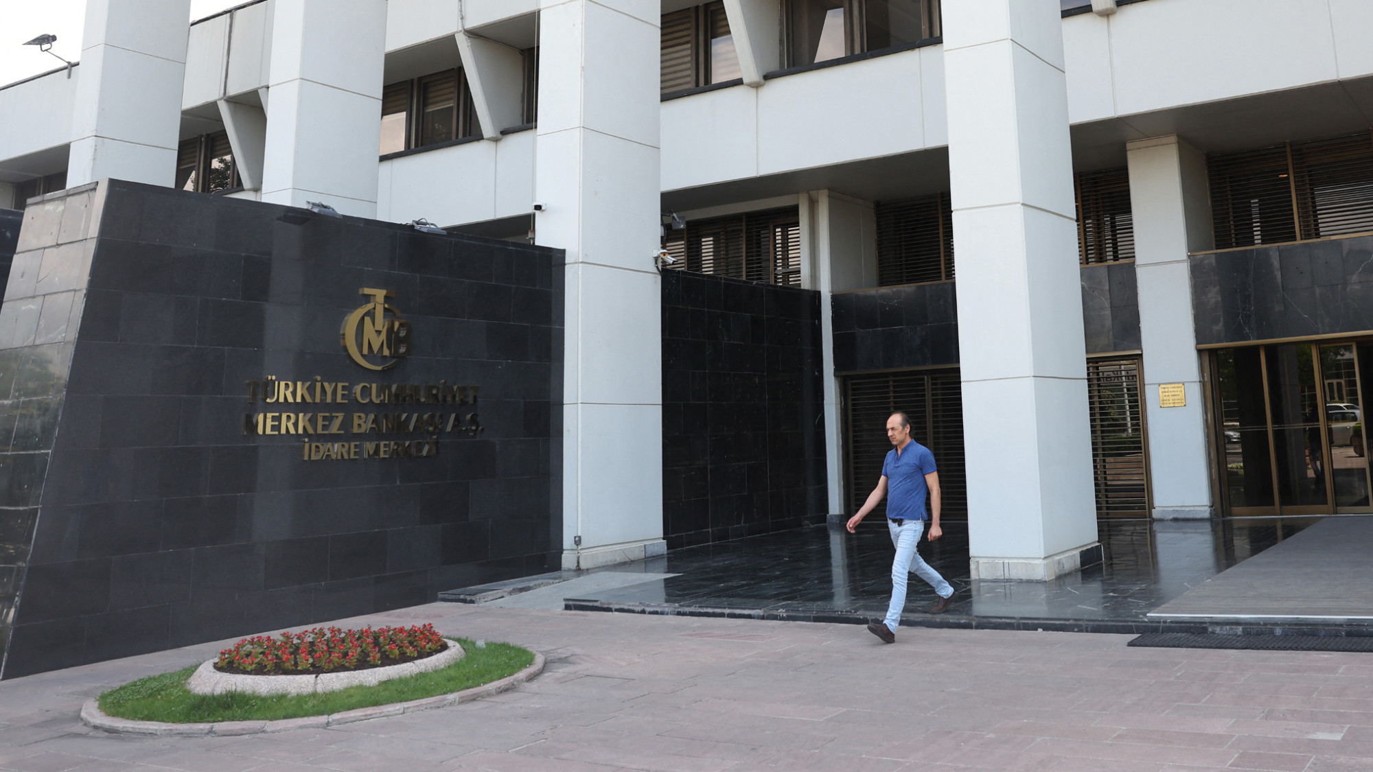 A man walks by the Central Bank of Turkey, in Ankara, on 9 June 2023 (Adem Altan/AFP)