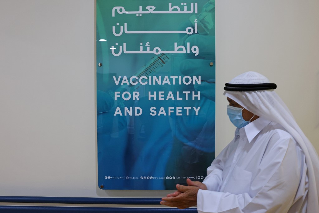 An Emirati man, wearing a protective mask, walks at al-Barsha Health Centre in the Gulf Emirate of Dubai on December 24, 2020.