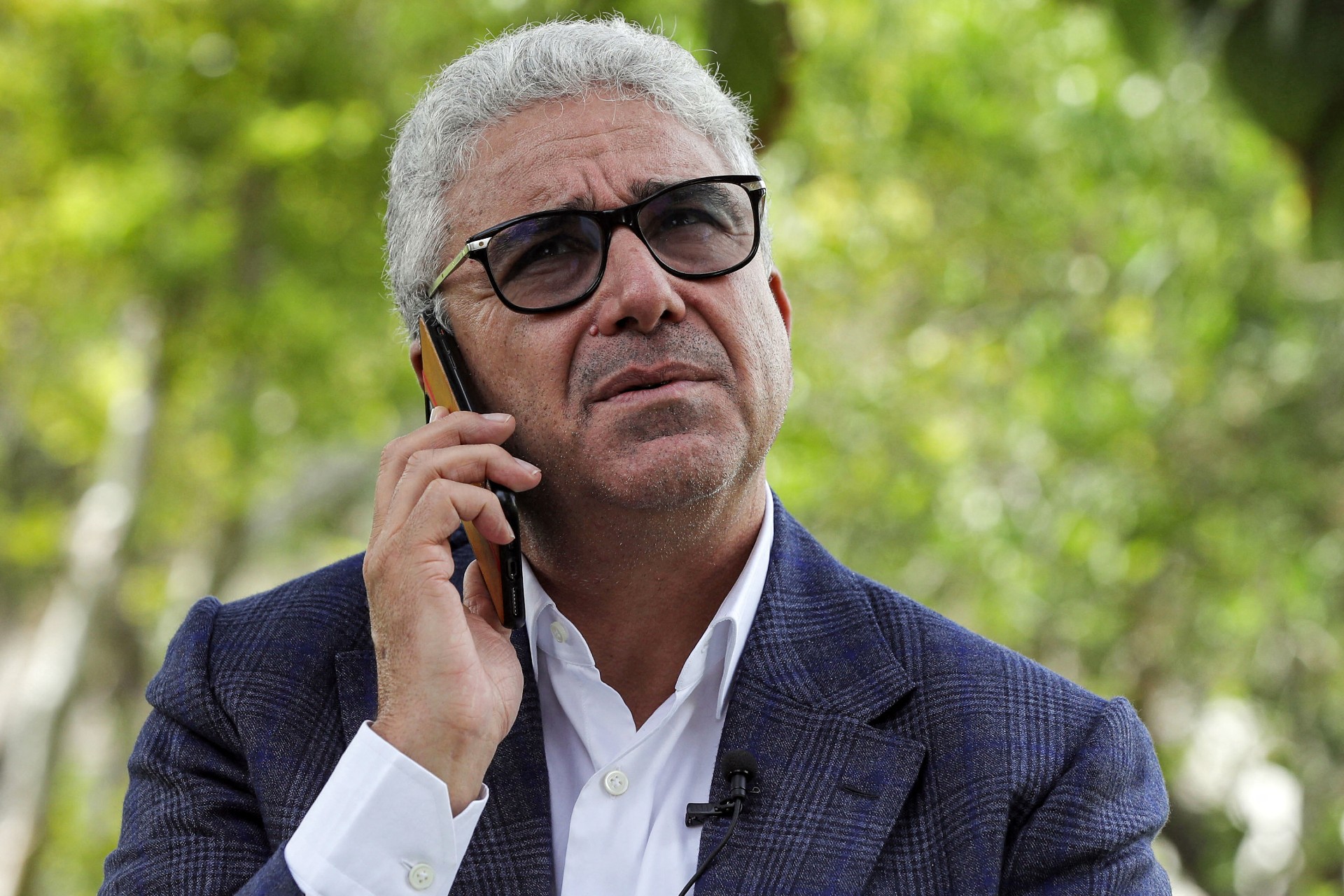 Fathi Bashagha, Libya's former interior minister, speaks on the phone during an interview with AFP in the capital Tripoli on October 6, 2021 (AFP)
