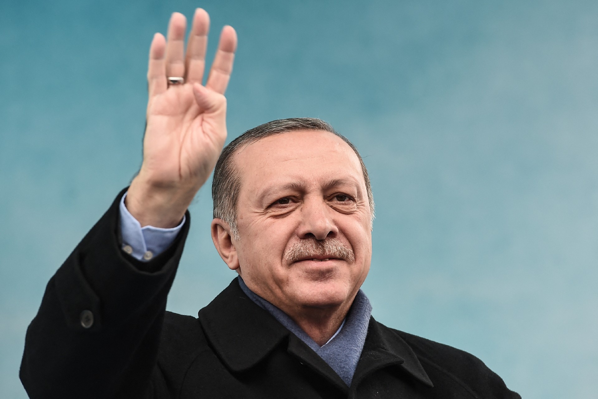 Erdogan greets supporters with the four-finger "Rabaa sign" as he arrives to a rally in Istanbul on 11 March, 2017 (AFP)