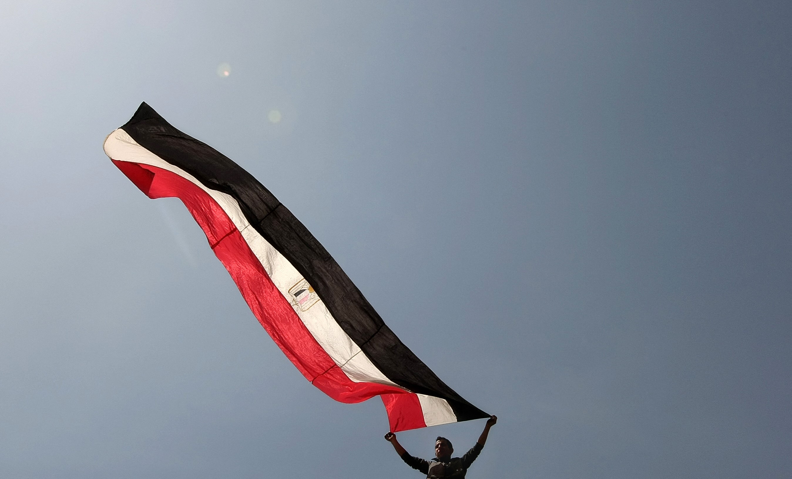 An Egyptian youth waves his national flag during a protest urging voters to reject an amended constitution at Tahrir Square in Cairo on March 18, 2011