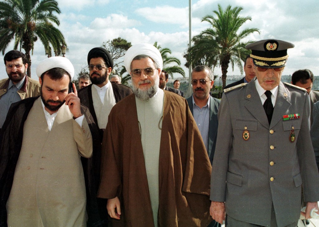 Hassan Ruhani (C) when serving as the Vice-President of the Iranian Parliament, walks with the Iranian ambassador in Rabat, Soubhani Nia (L), and colonel Major Hassan Skali (R) (AFP)