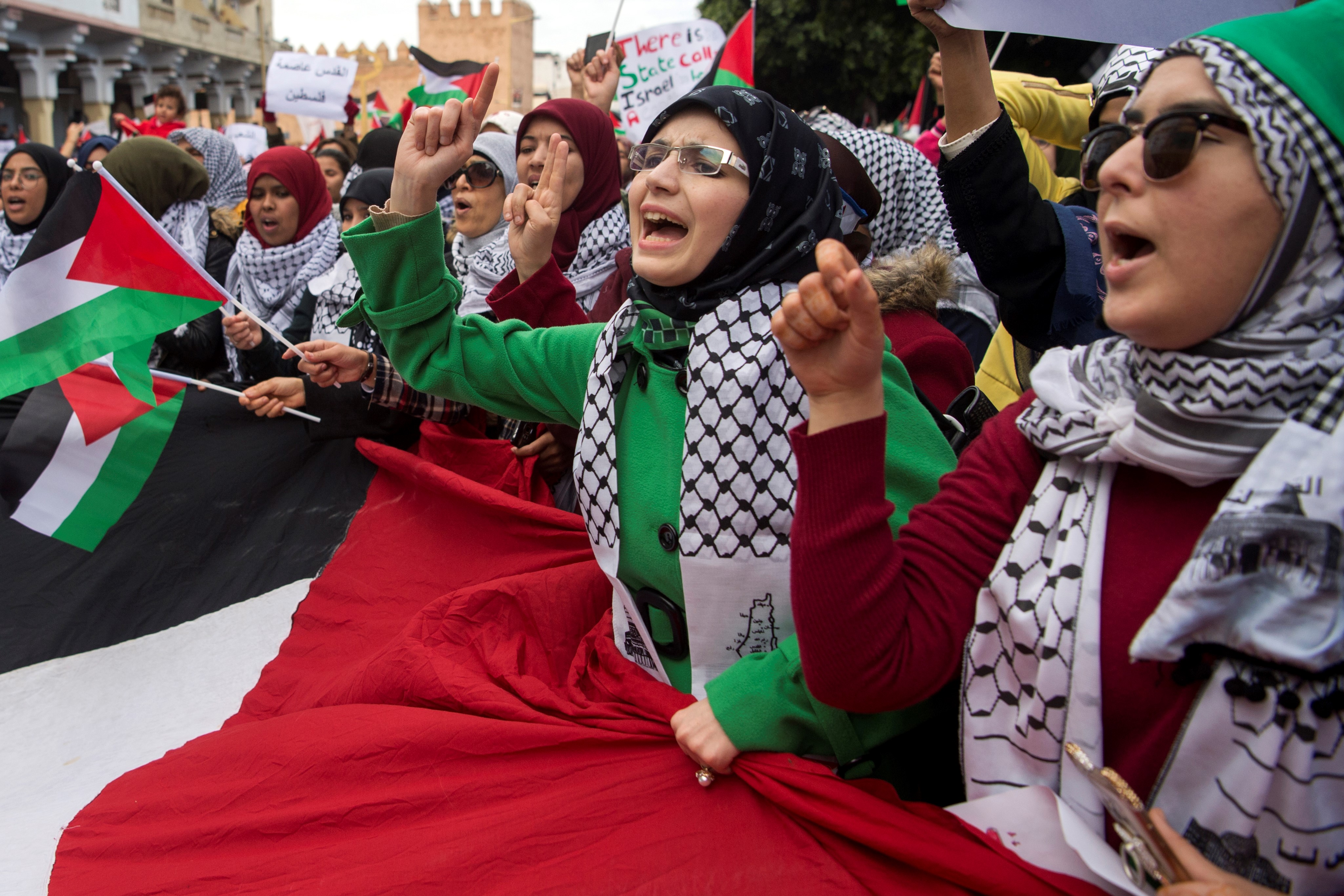  Pro-Palestinian protesters wave Palestinian flags and chant slogans against the US and Israel on December 10, 2017 in Rabat against