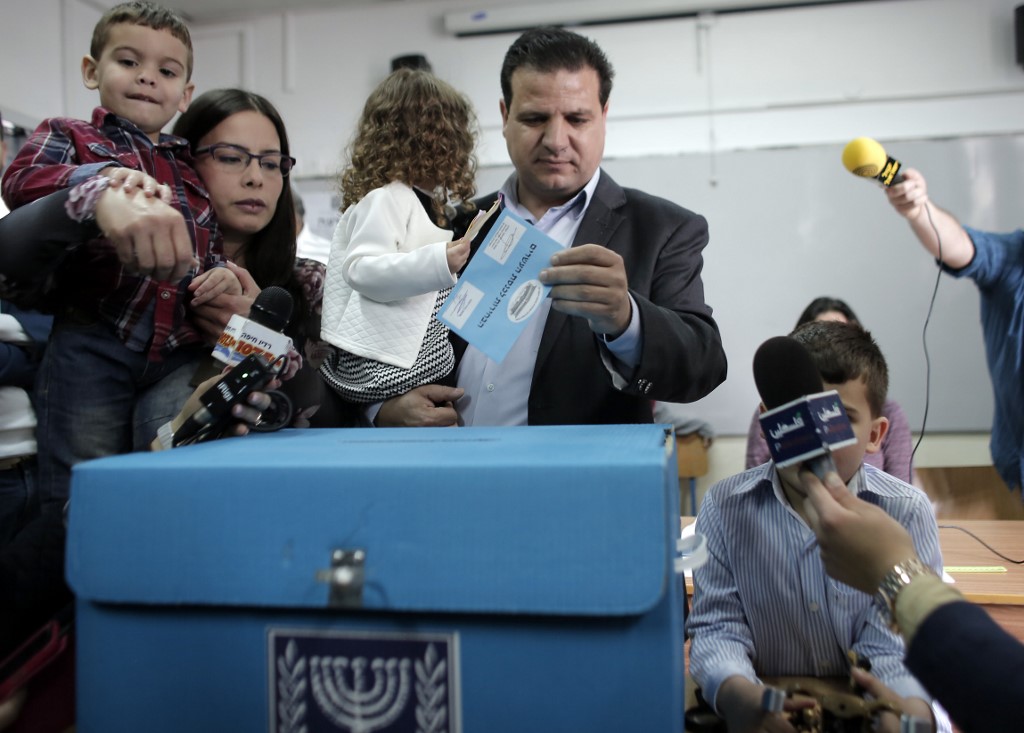Ayman Odeh, head of the Joint List, casts a ballot in 2015 (AFP)
