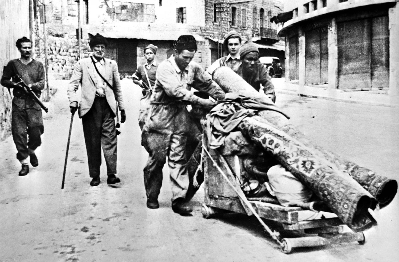 Members of the Zionist gang Haganah expel Palestinians from Haifa in April 1948 (AFP)