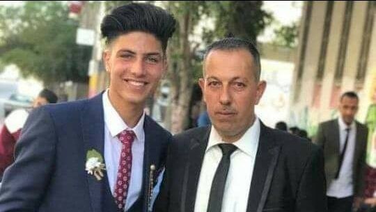 The Palestinian footballer (left) with his father, (right)